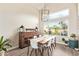 Bright dining room featuring a wooden table, stylish light fixture, and large windows at 213 E Vaughn Ave, Gilbert, AZ 85234