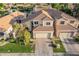 Well-maintained two-story home featuring a three-car garage, tile roof, and manicured front lawn at 213 E Vaughn Ave, Gilbert, AZ 85234