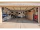 Spacious garage with epoxy floors, ample storage cabinets, and organized utility equipment at 213 E Vaughn Ave, Gilbert, AZ 85234