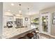 Open kitchen featuring granite countertops, a kitchen island with barstools, and stainless steel appliances at 213 E Vaughn Ave, Gilbert, AZ 85234