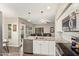 Modern kitchen with stainless steel appliances, granite countertops, and an open floor plan to the living area at 213 E Vaughn Ave, Gilbert, AZ 85234