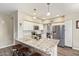 Well-lit kitchen with granite countertops, stainless steel appliances, and a kitchen island with seating at 213 E Vaughn Ave, Gilbert, AZ 85234