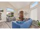 Bright living room with vaulted ceilings, large windows, stylish furniture, and a decorative hutch at 213 E Vaughn Ave, Gilbert, AZ 85234