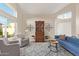 Bright living room with vaulted ceilings, large windows, stylish furniture, and a decorative hutch at 213 E Vaughn Ave, Gilbert, AZ 85234