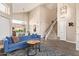 Spacious living room with vaulted ceilings, staircase, large windows, and stylish furniture at 213 E Vaughn Ave, Gilbert, AZ 85234