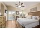 Spacious main bedroom featuring a ceiling fan, neutral color scheme, and sliding doors to a patio at 213 E Vaughn Ave, Gilbert, AZ 85234
