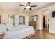 This main bedroom offers a ceiling fan, ensuite bathroom access, and natural light at 213 E Vaughn Ave, Gilbert, AZ 85234