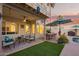Cozy covered patio with comfortable seating, dining space, and beautiful backyard views at 213 E Vaughn Ave, Gilbert, AZ 85234