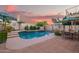 Sparkling pool featuring a waterfall, landscaped surroundings, and outdoor seating areas at 213 E Vaughn Ave, Gilbert, AZ 85234