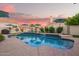 Relaxing pool with lush landscaping, outdoor seating, and shade umbrellas in a private yard at 213 E Vaughn Ave, Gilbert, AZ 85234