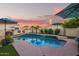 Beautiful pool with a waterfall, lush plantings, and shaded lounge areas for relaxation at 213 E Vaughn Ave, Gilbert, AZ 85234