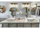 Stylish bathroom showcasing double sinks, vanity, decorative mirrors and modern fixtures at 21616 N 82Nd Ln, Peoria, AZ 85382