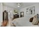 Bright bedroom with hardwood floors, television, dresser, and large mirror at 21616 N 82Nd Ln, Peoria, AZ 85382