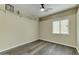 Spacious bedroom with a ceiling fan, gray laminate floors, and a window at 21616 N 82Nd Ln, Peoria, AZ 85382