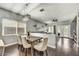 Open concept dining room with hardwood floors, modern lighting, and seamless transition to the living space at 21616 N 82Nd Ln, Peoria, AZ 85382