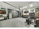 Organized garage with custom cabinets, ample storage, and epoxy flooring at 21616 N 82Nd Ln, Peoria, AZ 85382