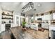 Bright, modern kitchen with white cabinets, stainless steel appliances, a dining table, and open shelving at 21616 N 82Nd Ln, Peoria, AZ 85382