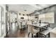 Eat-in kitchen featuring white cabinetry, granite counters, stainless appliances, and wood floors at 21616 N 82Nd Ln, Peoria, AZ 85382