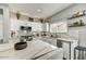 Modern kitchen featuring marble countertops, white cabinets, stainless steel appliances, and an open layout at 21616 N 82Nd Ln, Peoria, AZ 85382