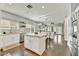 Stylish kitchen with an island, white cabinetry, stainless steel appliances, and hardwood floors at 21616 N 82Nd Ln, Peoria, AZ 85382
