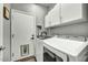 Functional laundry room featuring modern appliances and ample storage space at 21616 N 82Nd Ln, Peoria, AZ 85382