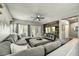 Spacious living room features a large sectional sofa and French doors to the exterior patio at 21616 N 82Nd Ln, Peoria, AZ 85382