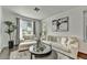 Elegant living room with ample natural light, plush seating, a stylish coffee table, and modern decor at 21616 N 82Nd Ln, Peoria, AZ 85382