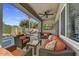Covered patio with outdoor seating, a ceiling fan, and a view of the pool at 21616 N 82Nd Ln, Peoria, AZ 85382