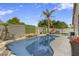 Beautiful backyard pool with lush landscaping, rock features, and outdoor seating at 21616 N 82Nd Ln, Peoria, AZ 85382