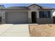 Charming single-story home featuring a neutral color scheme, a two-car garage, and a well-maintained front yard at 22360 W Monona Ln, Surprise, AZ 85387