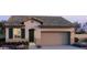 Charming single-story home with a spacious two-car garage, desert landscaping, and a tiled roof at 22360 W Monona Ln, Surprise, AZ 85387