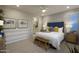 Serene main bedroom with soft lighting, decorative wallpaper, and access to the bathroom at 22360 W Monona Ln, Surprise, AZ 85387