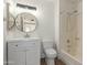 Updated bathroom featuring a modern vanity, round mirror, and a shower-tub combination for convenience at 2455 E Broadway Rd # 39, Mesa, AZ 85204