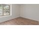 Bright bedroom features hardwood flooring and a large window with natural light at 2455 E Broadway Rd # 39, Mesa, AZ 85204