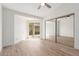 Bedroom featuring a ceiling fan, wood-look floors, and a sliding glass door at 2455 E Broadway Rd # 39, Mesa, AZ 85204