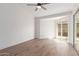 Bright bedroom featuring wood-look floors and sliding glass door at 2455 E Broadway Rd # 39, Mesa, AZ 85204