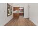 Bright dining area showcasing wood flooring, light walls, and a view into the adjacent kitchen, perfect for entertaining at 2455 E Broadway Rd # 39, Mesa, AZ 85204