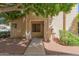 Inviting townhome exterior with covered entry, mature trees, and neat landscaping creates curb appeal at 2455 E Broadway Rd # 39, Mesa, AZ 85204