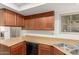 Well-lit kitchen with wood cabinets, neutral countertops and updated appliances at 2455 E Broadway Rd # 39, Mesa, AZ 85204