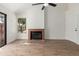 Bright living room featuring wood floors, a cozy fireplace, and ample natural light through large windows at 2455 E Broadway Rd # 39, Mesa, AZ 85204