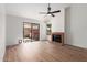 Open living space featuring wood flooring, a cozy fireplace, and sliding glass doors for natural light and access at 2455 E Broadway Rd # 39, Mesa, AZ 85204