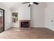 Bright living room featuring wood floors, a cozy fireplace, and ample natural light through large windows at 2455 E Broadway Rd # 39, Mesa, AZ 85204