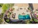 Overhead view of backyard oasis with pool, hot tub, outdoor dining, and seating areas, set in desert landscaping at 2674 N Saide Ln, Buckeye, AZ 85396