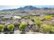 Stunning aerial view of a well-maintained home nestled in a beautiful community with mountain views at 2674 N Saide Ln, Buckeye, AZ 85396