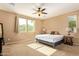 Bedroom with carpet floors, natural light from the windows, and a ceiling fan at 2674 N Saide Ln, Buckeye, AZ 85396