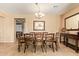 Elegant dining room with tiled floor, large table, and decorative chandelier at 2674 N Saide Ln, Buckeye, AZ 85396