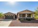 Charming single-story home featuring a welcoming front porch and a well-maintained desert landscape at 2674 N Saide Ln, Buckeye, AZ 85396