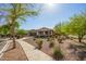 Attractive single-level home with desert landscaping, a covered porch, and a two-car garage at 2674 N Saide Ln, Buckeye, AZ 85396