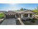 Attractive single-story home with a covered front porch, two-car garage, and mountain views at 2674 N Saide Ln, Buckeye, AZ 85396