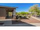 Welcoming front porch with stone accents, surrounded by well-maintained landscaping and mature trees at 2674 N Saide Ln, Buckeye, AZ 85396